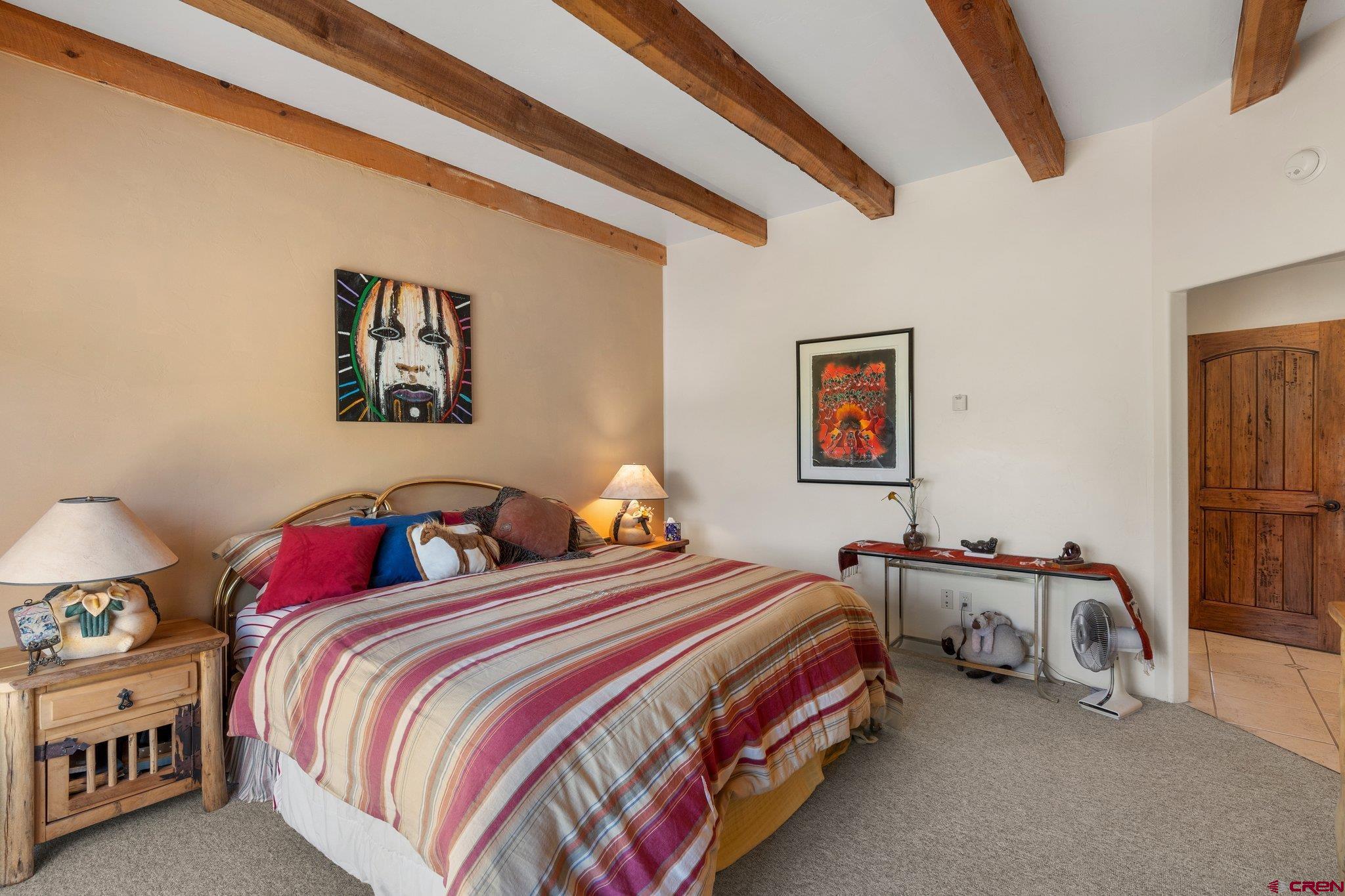 285 South Fork Road Durango, CO 81303 - Photo 13 of 31 a bedroom with two beds and a chandelier
