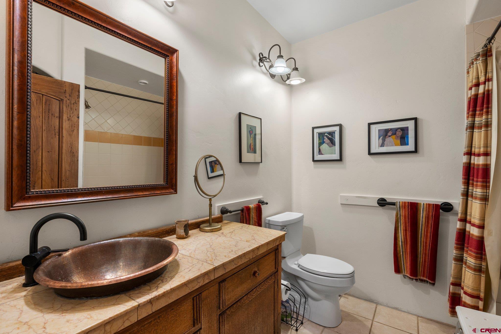285 South Fork Road Durango, CO 81303 - Photo 23 of 31 a bathroom with a granite countertop toilet sink and mirror