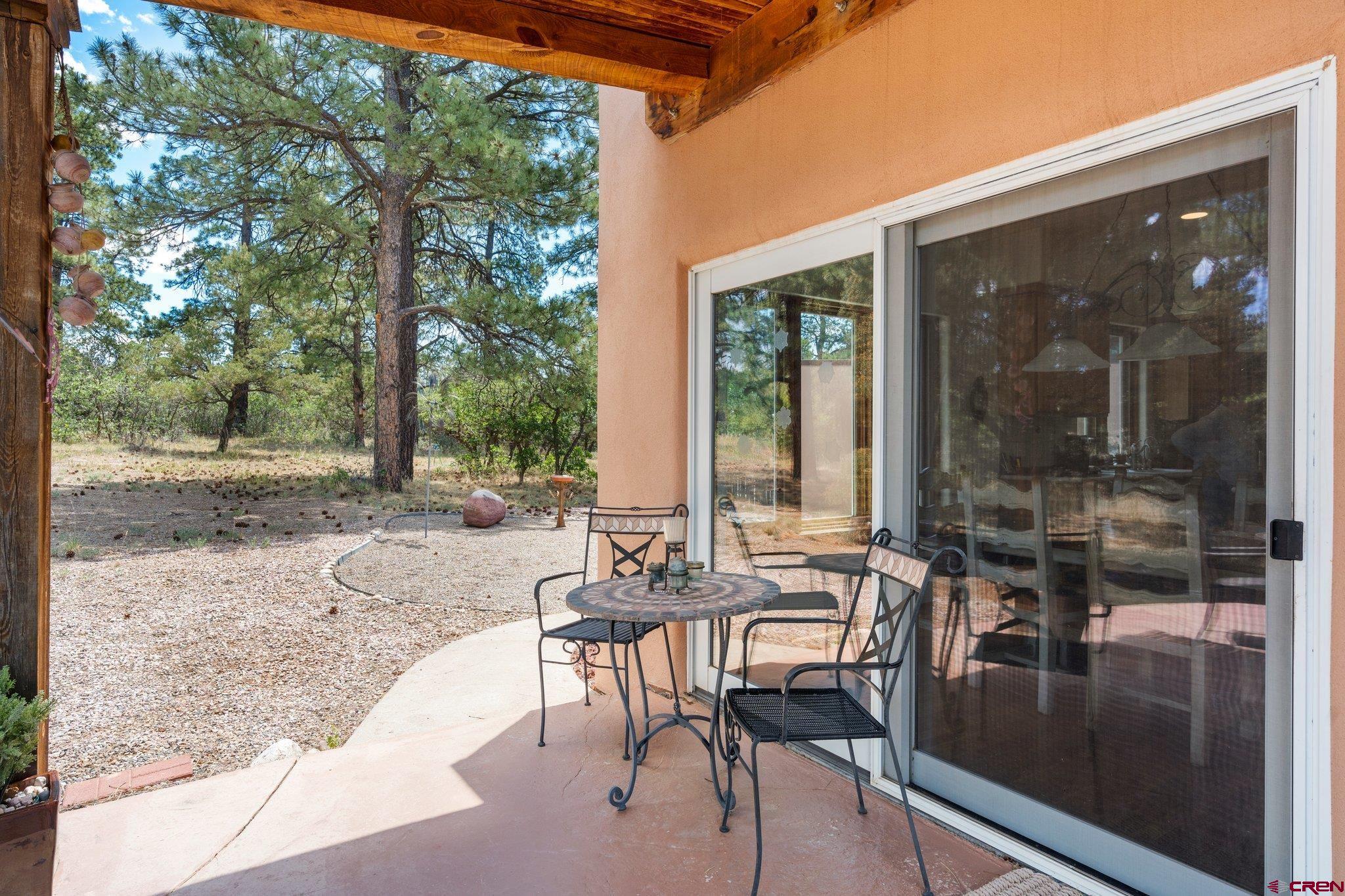285 South Fork Road Durango, CO 81303 - Photo 26 of 31 a view of a patio with table and chairs with wooden floor and floor to ceiling window