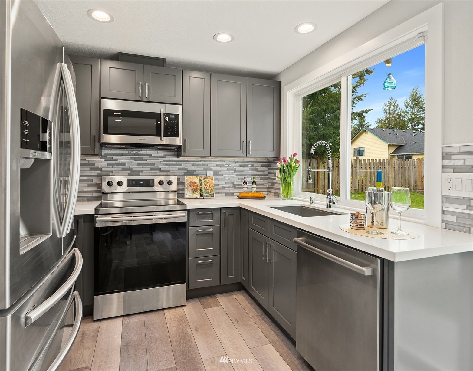 4308 Southeast 2nd Place Renton, WA 98059 - Photo 9 of 26 a kitchen with stainless steel appliances a stove sink and microwave