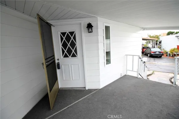 a view of hallway with stairs and furniture
