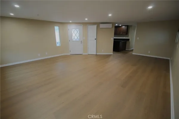 a view of a kitchen with a sink and a refrigerator