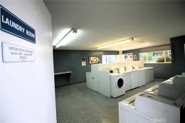 a utility room with cabinets washer and dryer