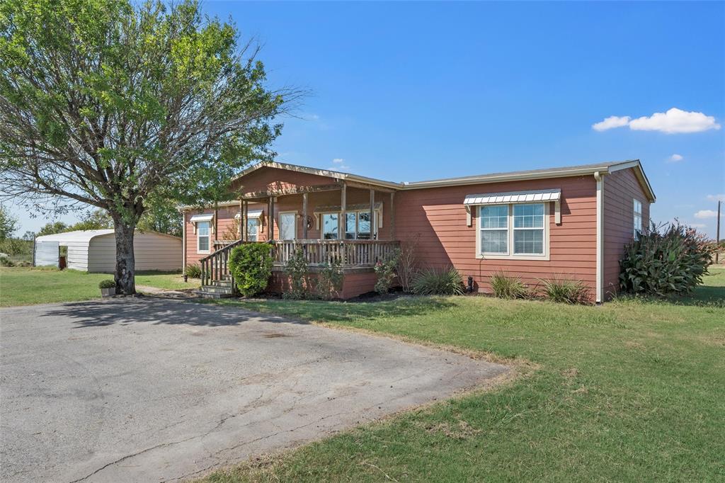 3449 Bluhm Road West, TX 76691 - Photo 6 of 40 a front view of a house with a garden