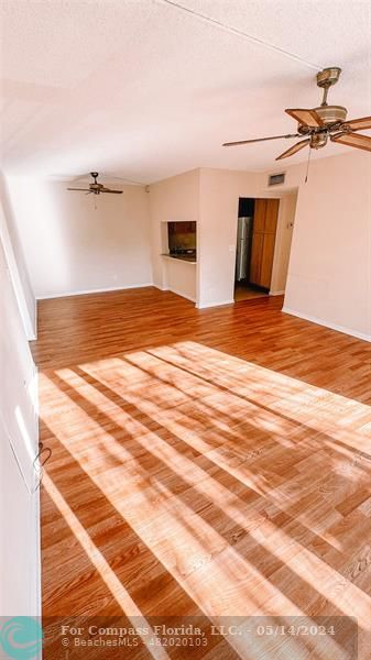 a view of a room with wooden floor