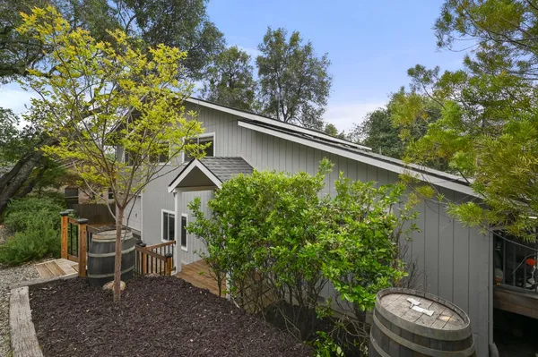 a view of a backyard with plants and a patio