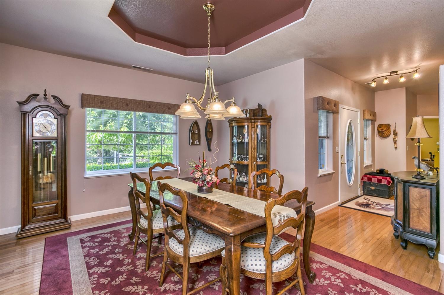 165 Creeks Road Grants Pass, OR 97526 - Photo 7 of 31 a view of a dining room with furniture a chandelier and wooden floor