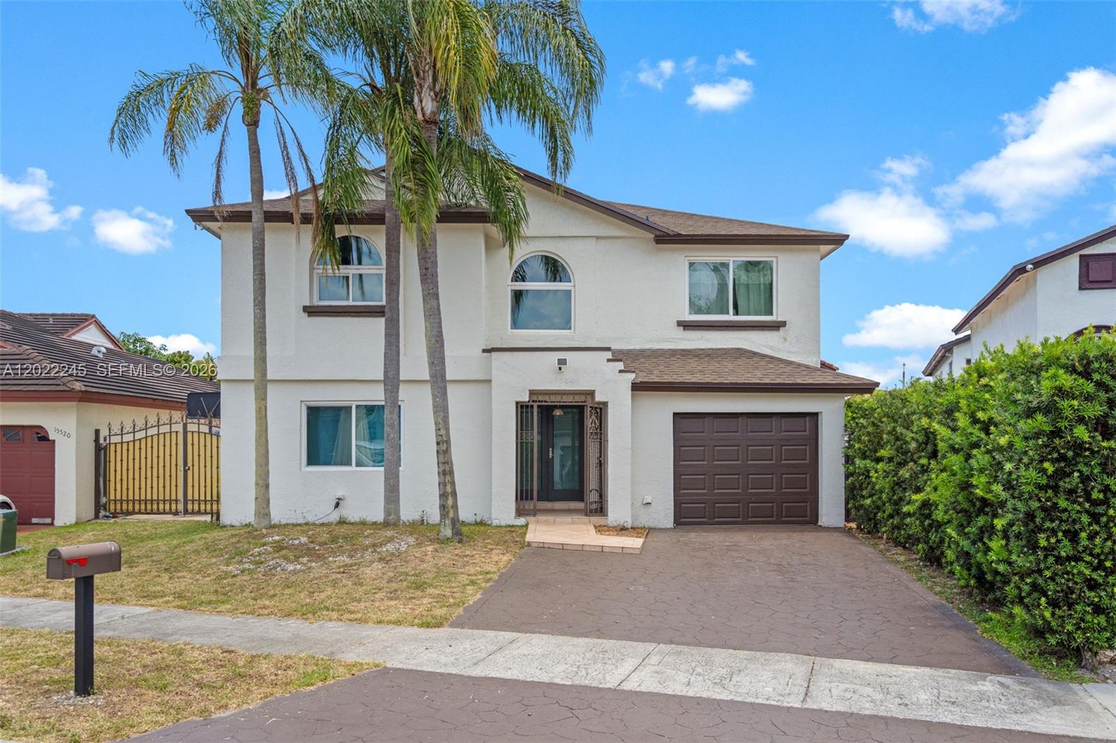 15530 Southwest 59th Street Miami, FL 33193 - Photo 1 of 58 a front view of a house with a yard and garage