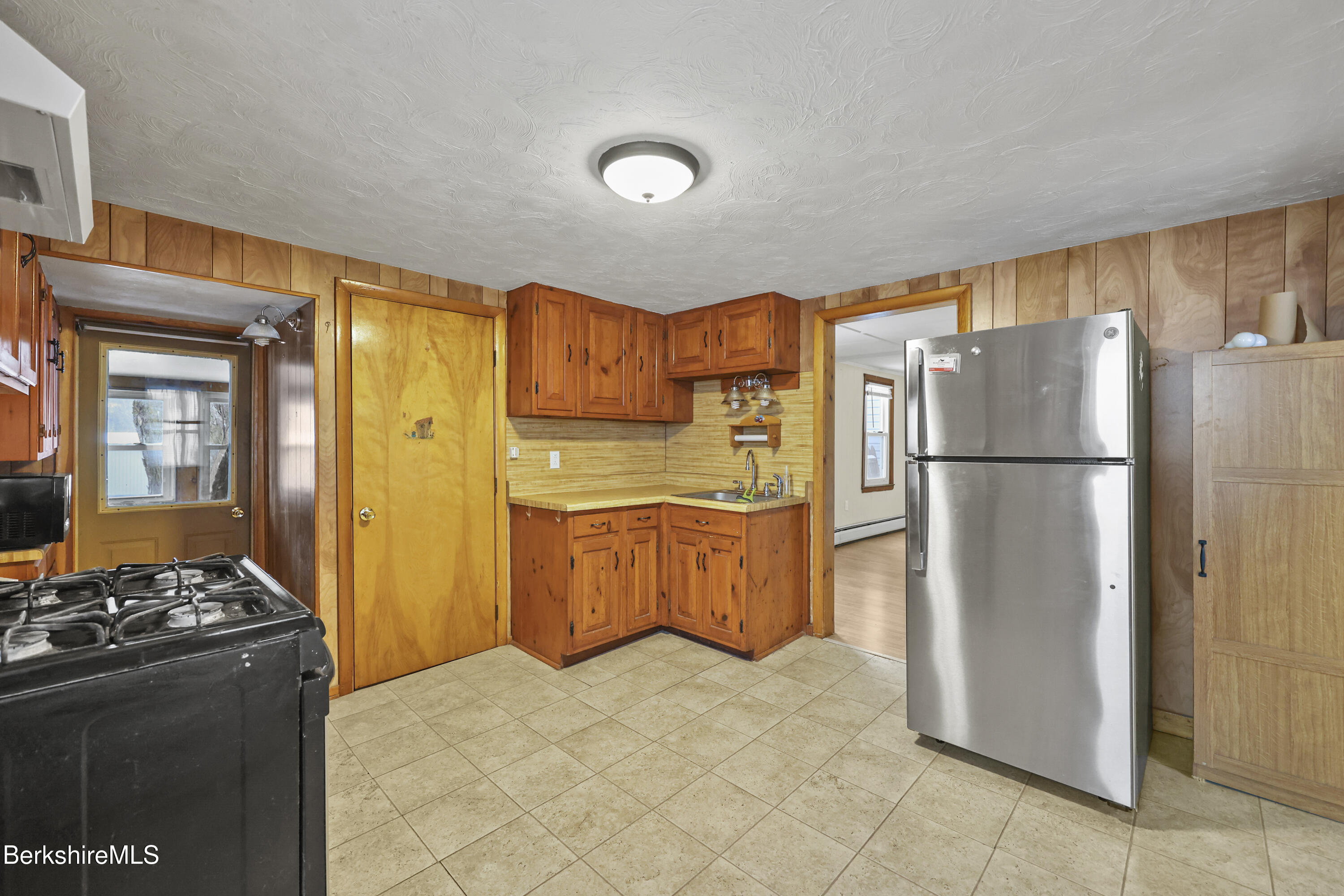 176 North Summer Street Adams, MA 01220 - Photo 11 of 31 a kitchen with stainless steel appliances granite countertop a refrigerator and a stove