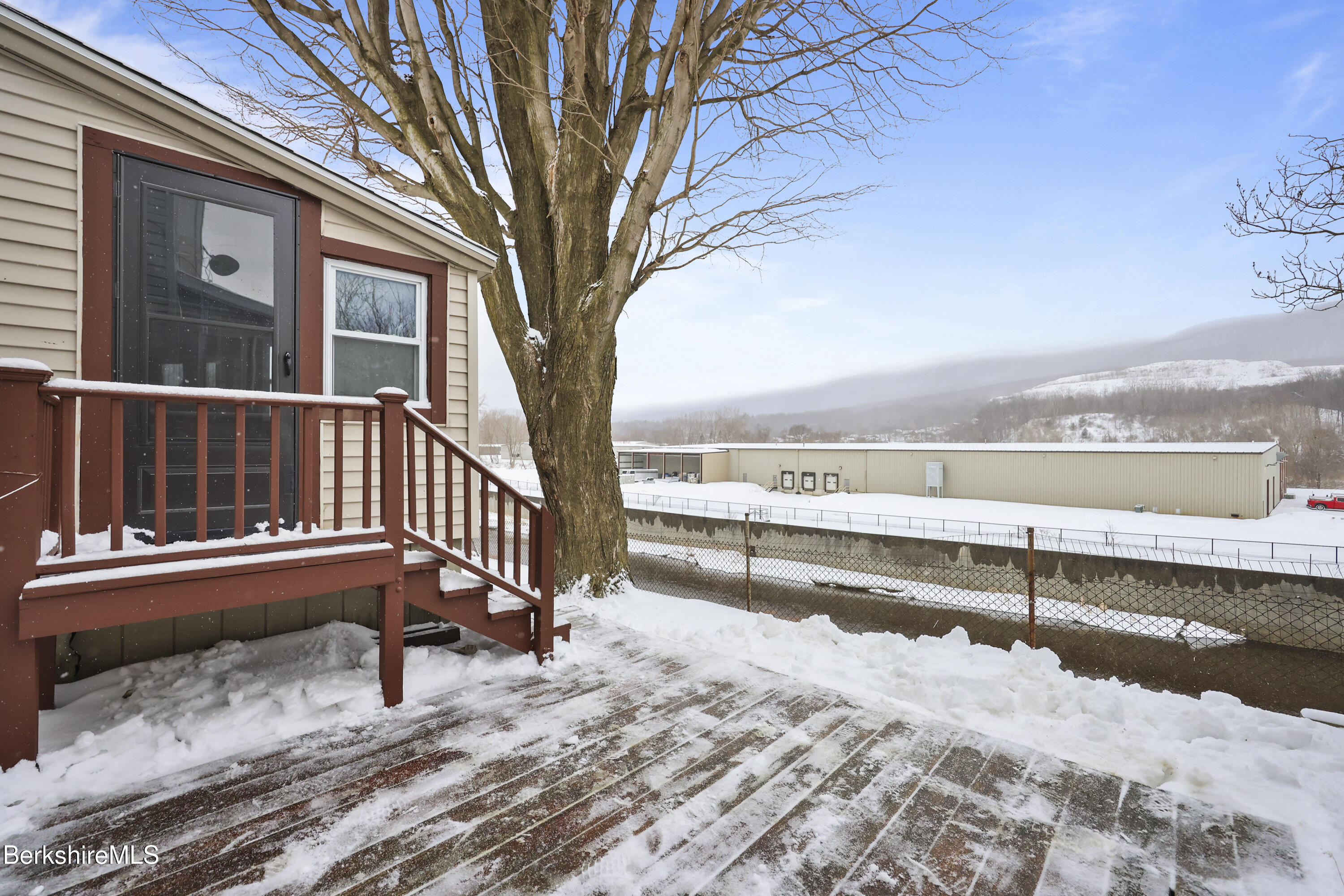 176 North Summer Street Adams, MA 01220 - Photo 27 of 31 a view of a roof deck with wooden fence and a floor to ceiling window