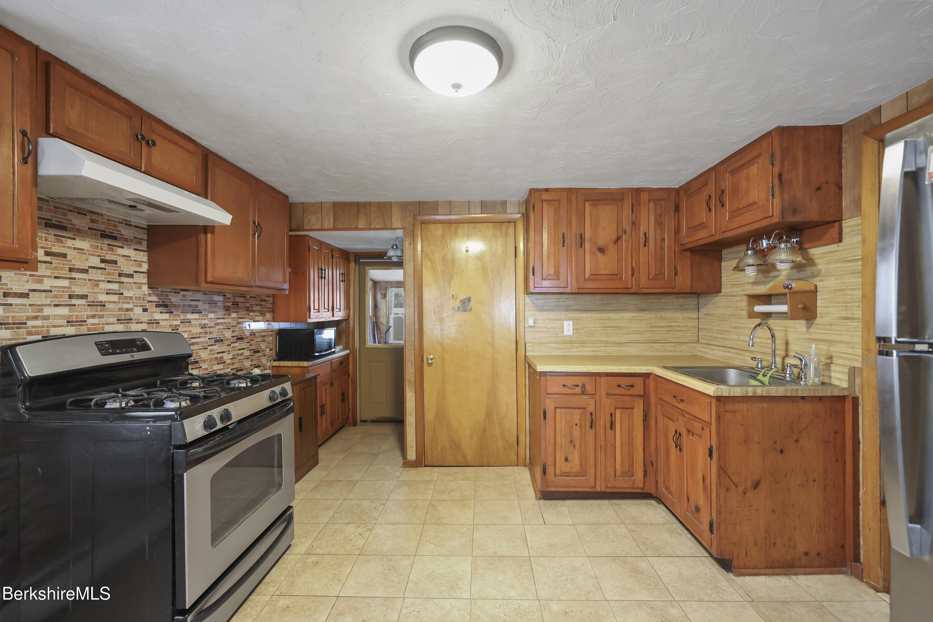 176 North Summer Street Adams, MA 01220 - Photo 8 of 31 a kitchen with stainless steel appliances granite countertop a stove a sink dishwasher and a refrigerator