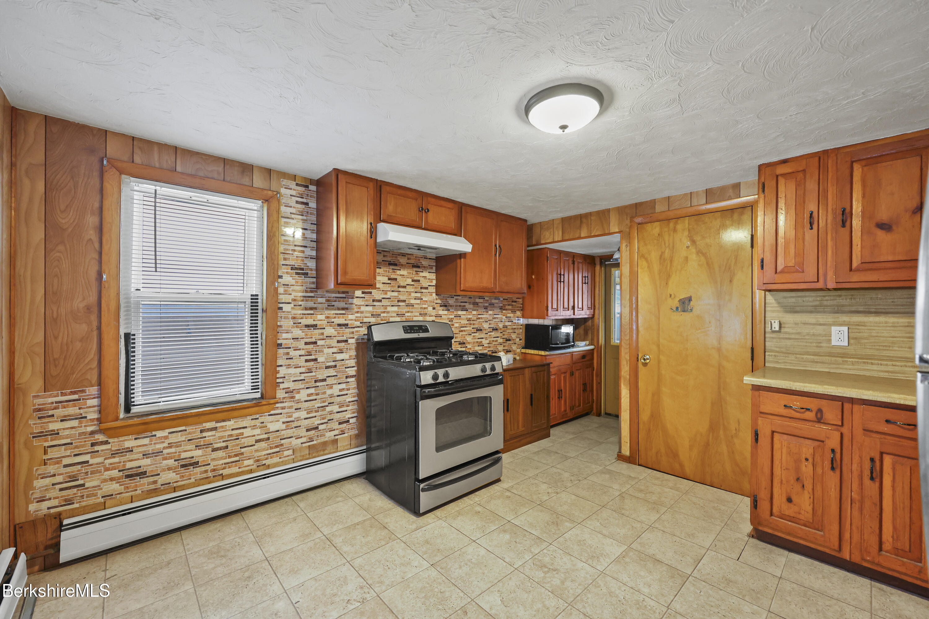 176 North Summer Street Adams, MA 01220 - Photo 9 of 31 a kitchen with stainless steel appliances granite countertop a refrigerator and wooden cabinets