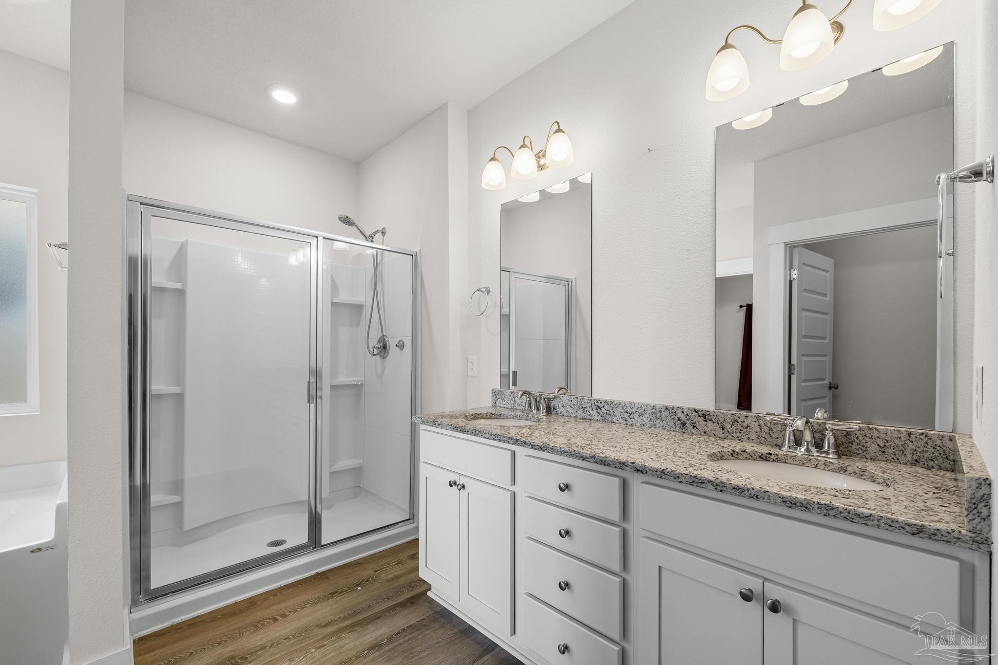 4074 Blaney Lane Pace, FL 32571 - Photo 20 of 59 a bathroom with a granite countertop sink a mirror and shower
