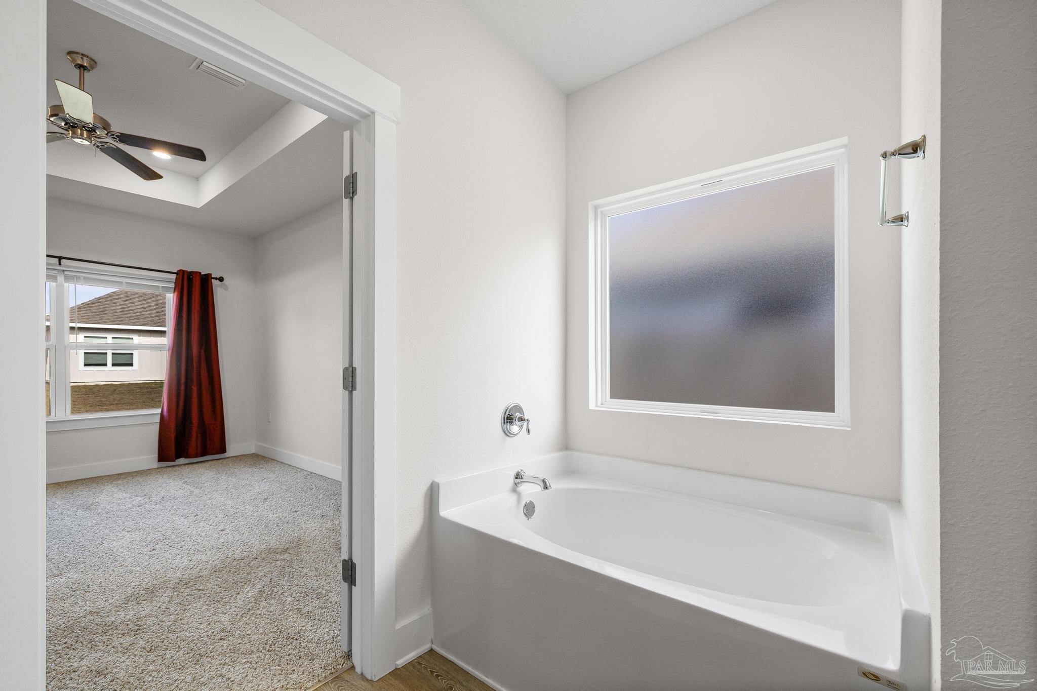 4074 Blaney Lane Pace, FL 32571 - Photo 21 of 59 a spacious bathroom with a bathtub and a shower