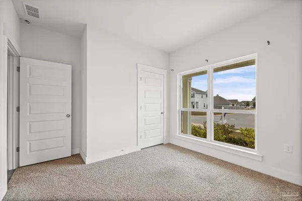 a spacious bedroom with a bed and a table