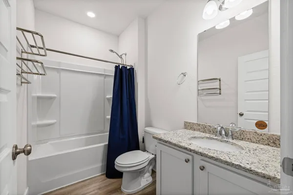 an empty room with chandelier fan