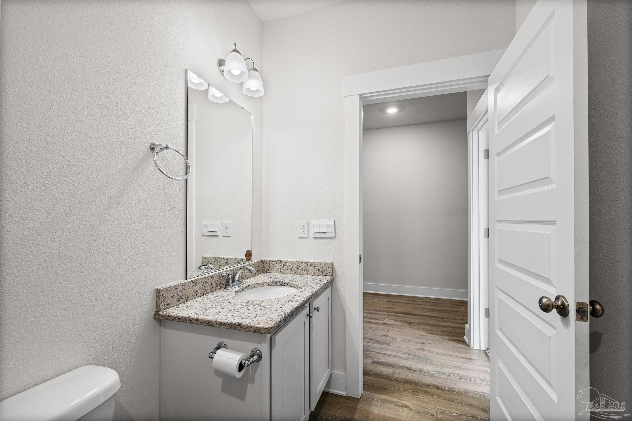 4074 Blaney Lane Pace, FL 32571 - Photo 27 of 59 a bathroom with a granite countertop sink a toilet and shower