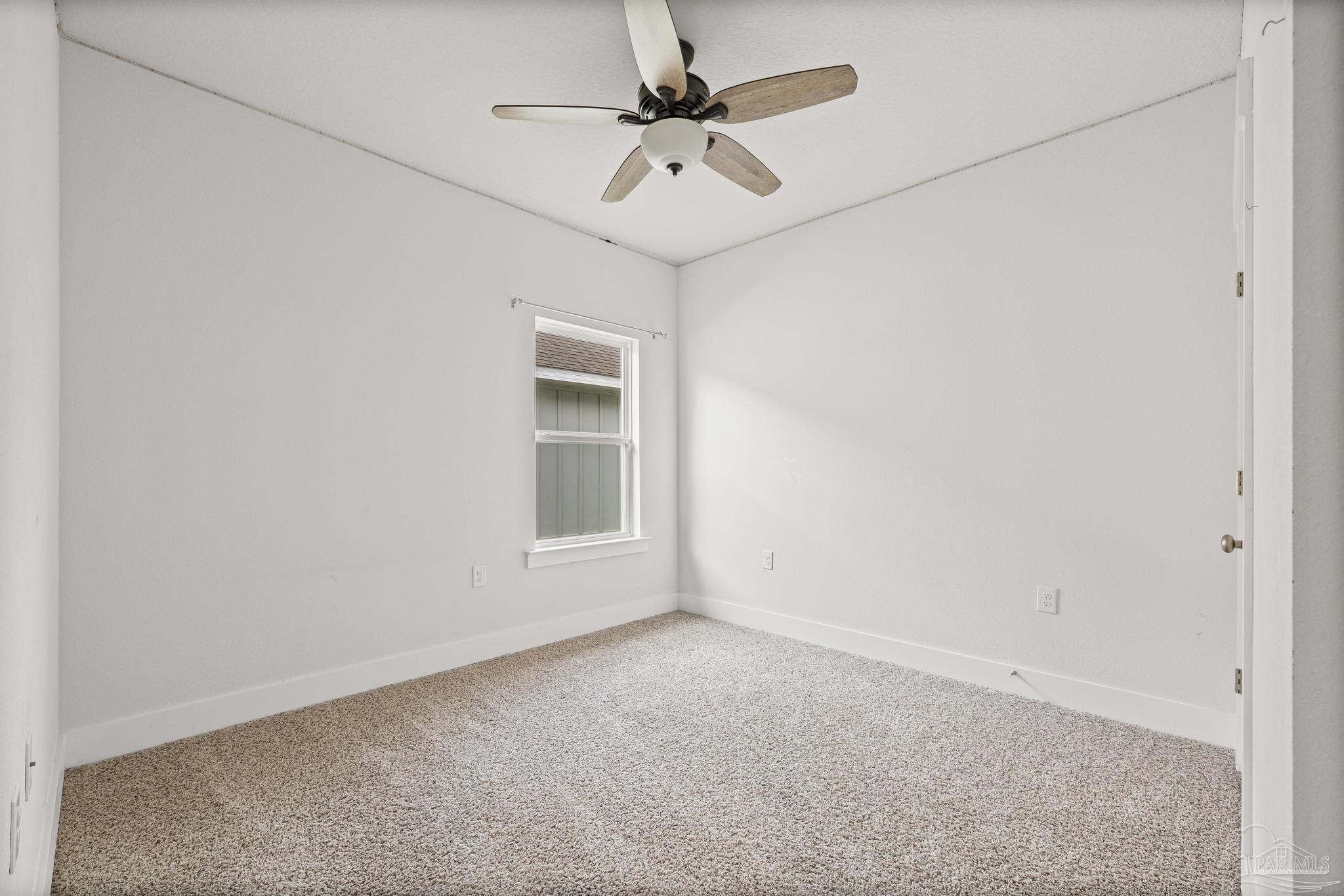 4074 Blaney Lane Pace, FL 32571 - Photo 28 of 59 an empty room with a window and a ceiling fan