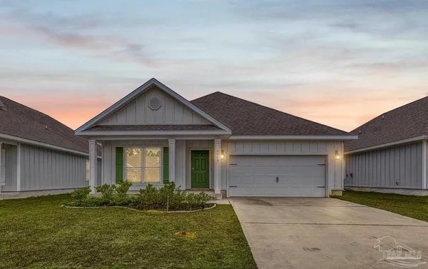 a view of a big house with a big yard and large trees