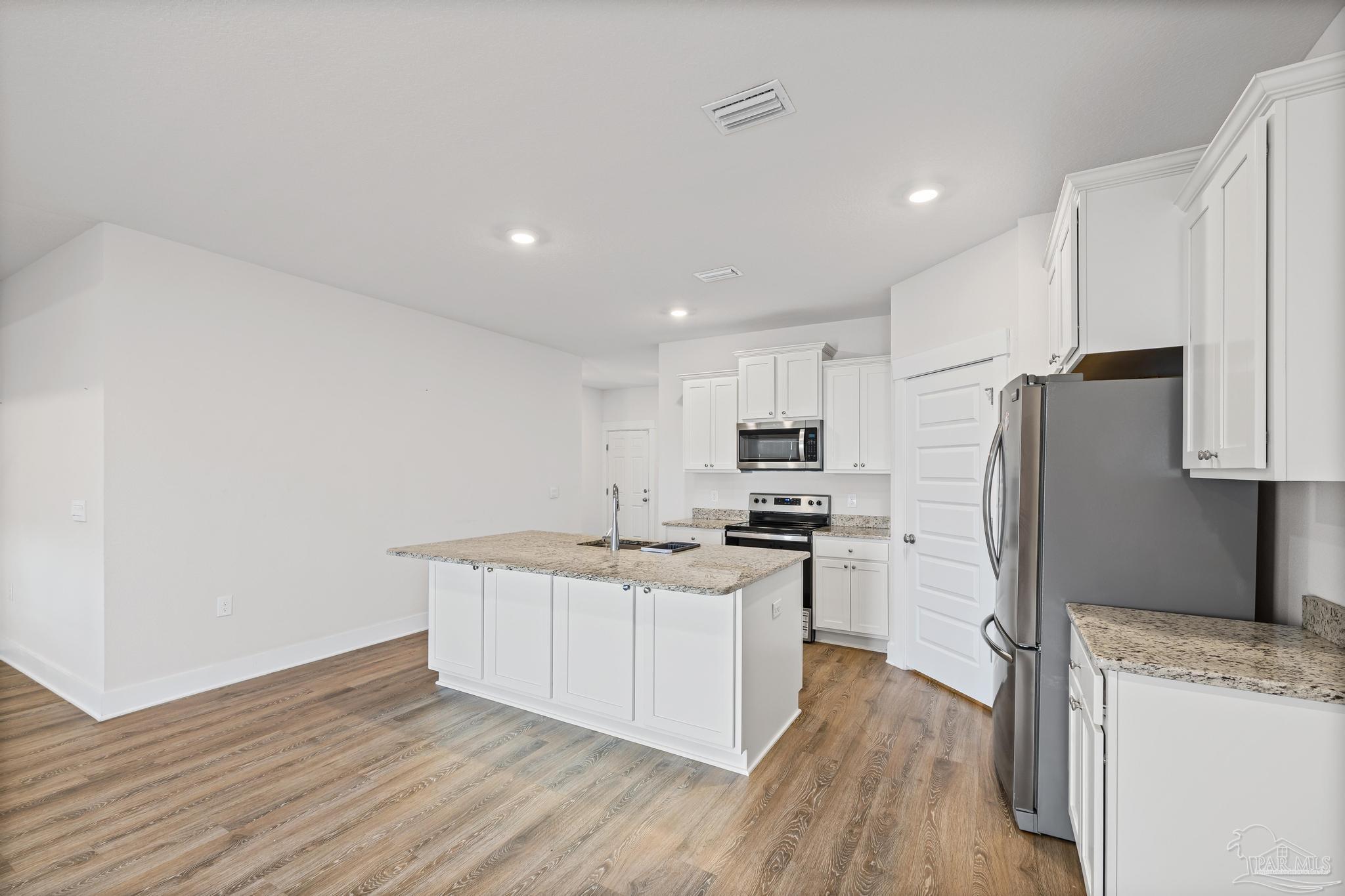 4074 Blaney Lane Pace, FL 32571 - Photo 39 of 59 a kitchen with stainless steel appliances a refrigerator and a stove top oven