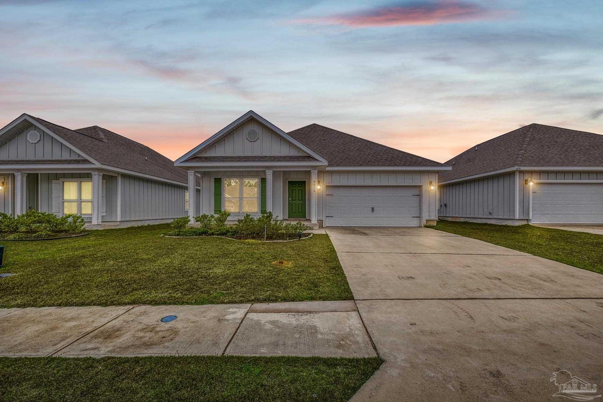 4074 Blaney Lane Pace, FL 32571 - Photo 4 of 59 a view of a big house with a big yard and large trees