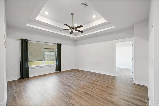 a view of a room that has a bed and a window