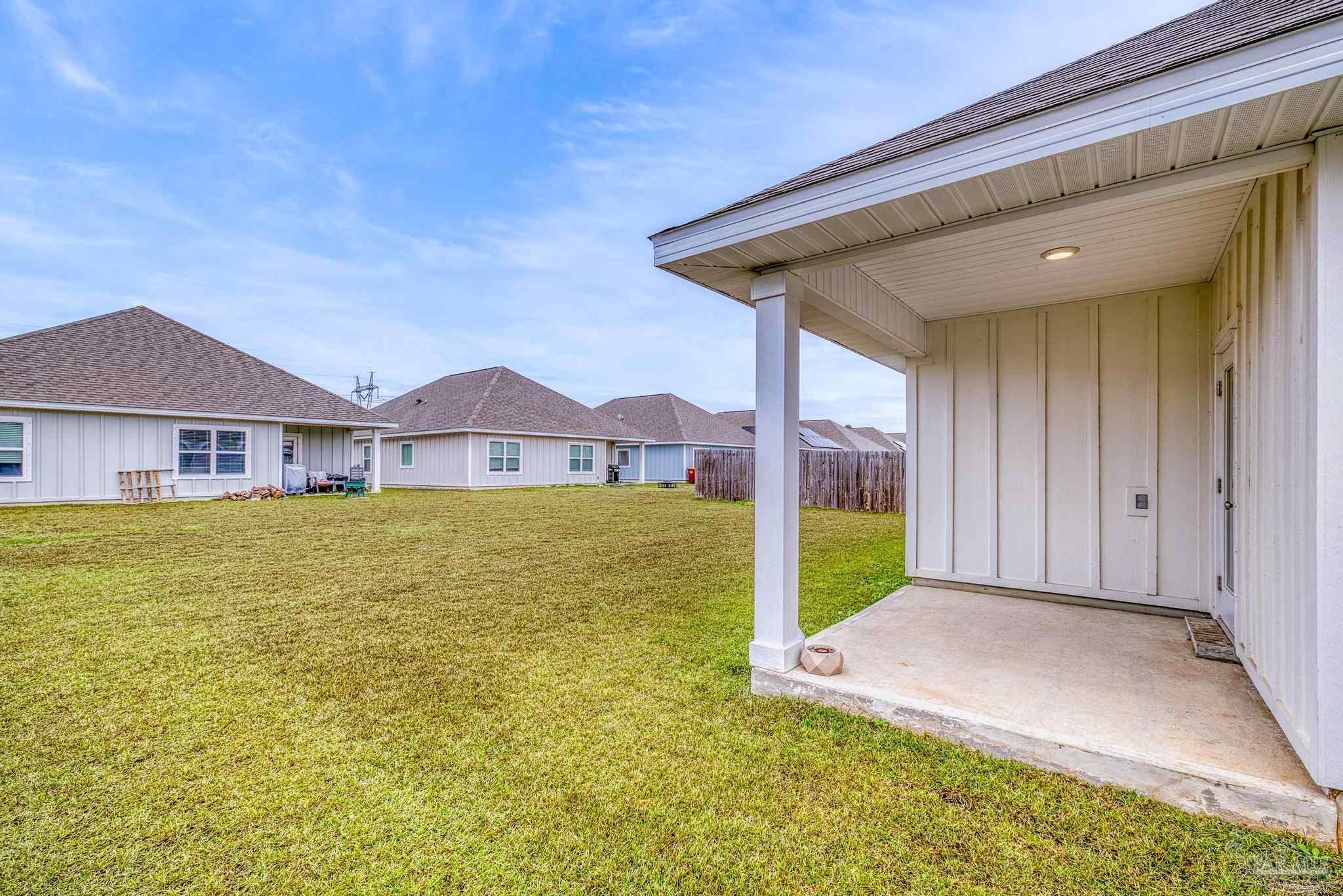 4074 Blaney Lane Pace, FL 32571 - Photo 52 of 59 a view of an house that has a swimming pool with a yard
