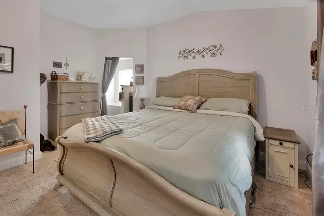 a bedroom with a bed and a night stand