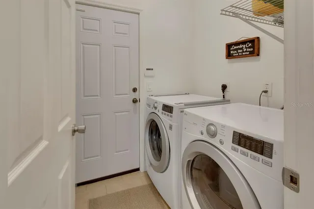 a view of a storage & utility room with dryer and washer