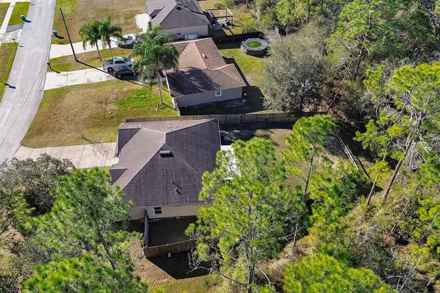 an aerial view of house with yard swimming pool and outdoor seating