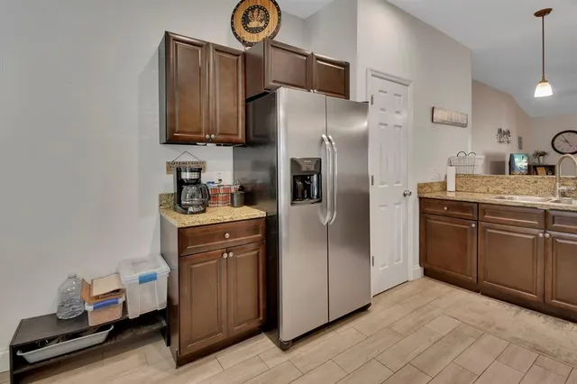 a kitchen with stainless steel appliances a refrigerator sink and microwave