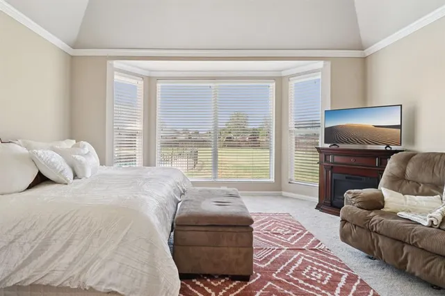 a bedroom with furniture and a large window