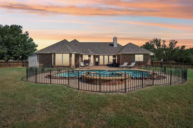 a view of a house with wooden deck and a big yard