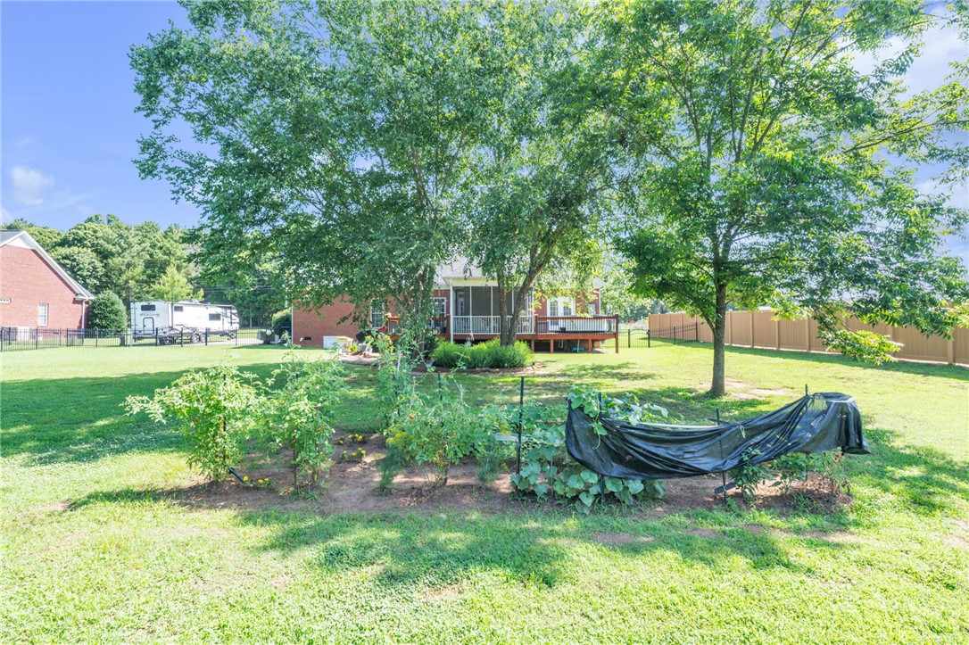 648 Mountain View Road Williamston, SC 29697 - Photo 36 of 42 A verdant yard with an active garden and ample space for outdoor enjoyment.