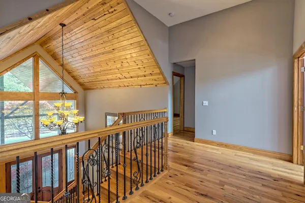 a view of a room with wooden floor and windows