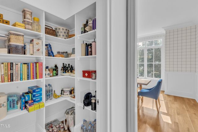 a room with a book shelf and a bath tub