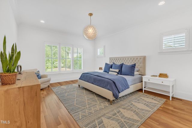 a bedroom with bed and a large window