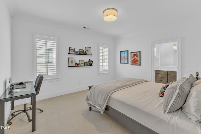 a bedroom with a bed a table and chair