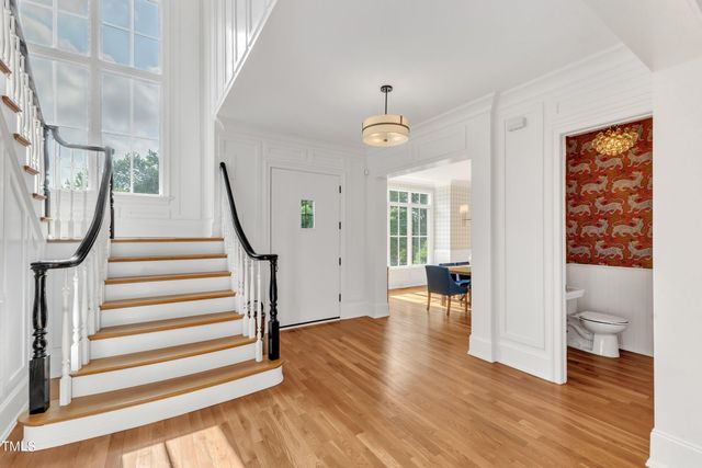 a view of entryway and hall with wooden floor