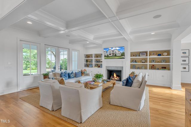 a living room with furniture fireplace and a large window