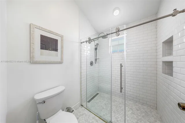 a bathroom with a shower toilet and sink