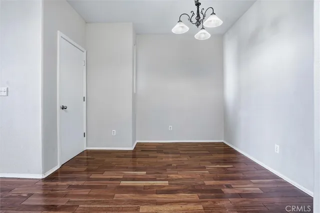 a view of a room with wooden floor and ceiling fan