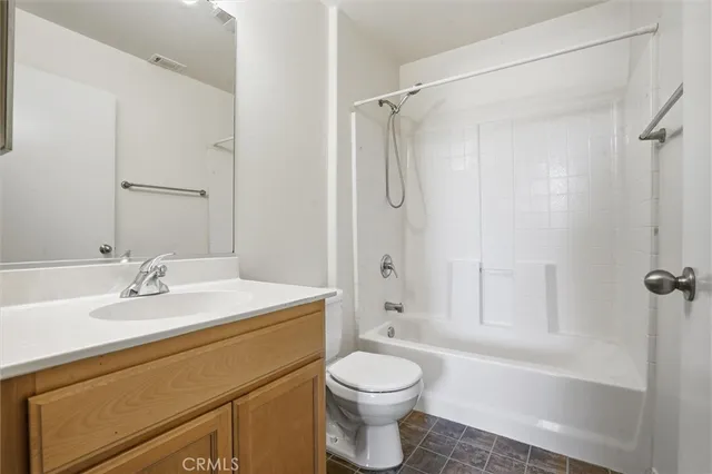 a bathroom with a sink toilet vanity and shower