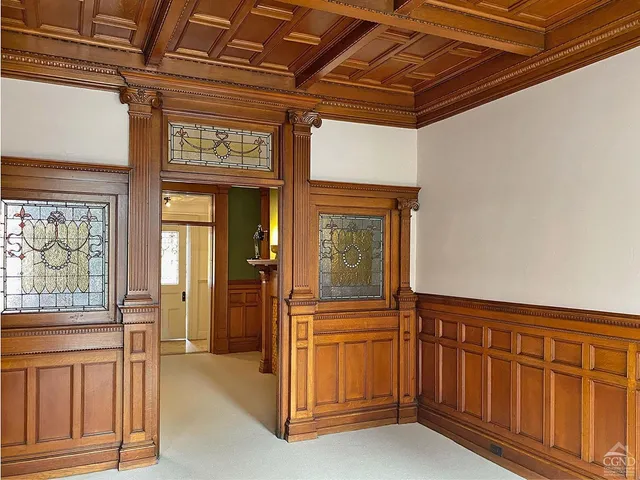 a view of a hallway with entryway a chandelier and front door