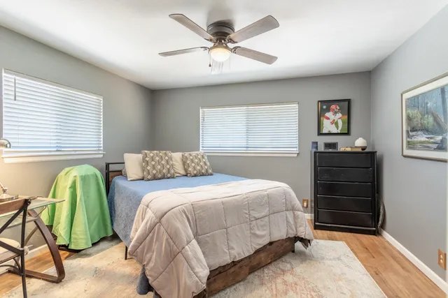 a bedroom with a bed and a chandelier