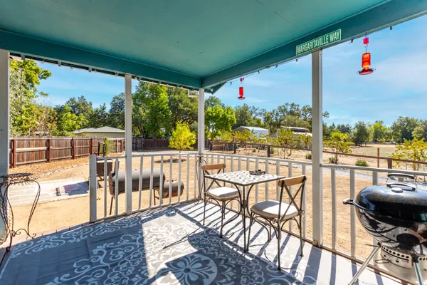 a view of a balcony with chairs and a table