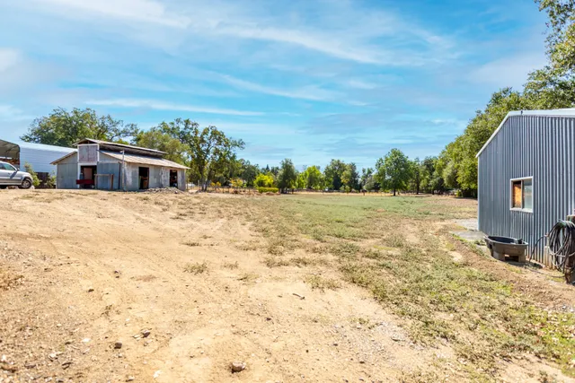 a backyard of a house with large trees