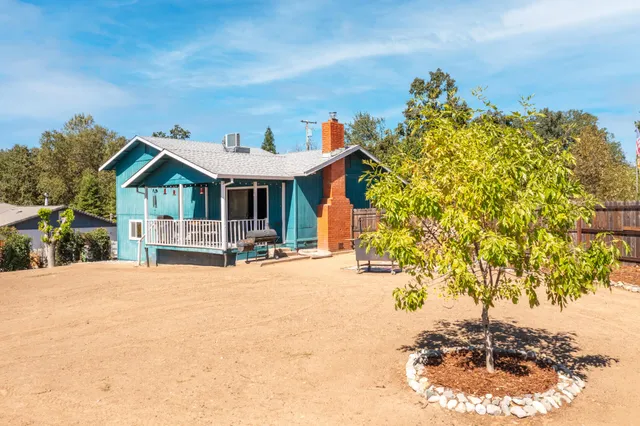 a view of a house with backyard porch and sitting area