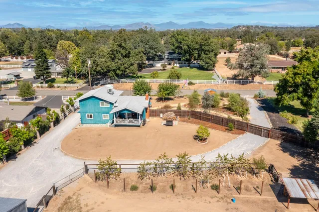 an aerial view of a house with outdoor space