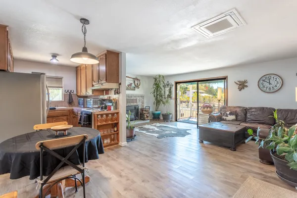 a living room with fireplace furniture and a wooden floor